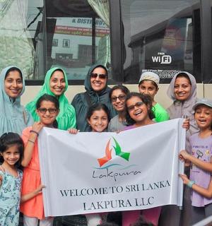 a group of people standing in front of a bus