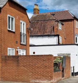 a brick house with a brick wall next to a building