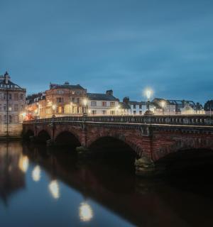 a bridge over a river in a city at night