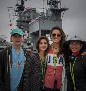 a group of people posing for a picture on a ship