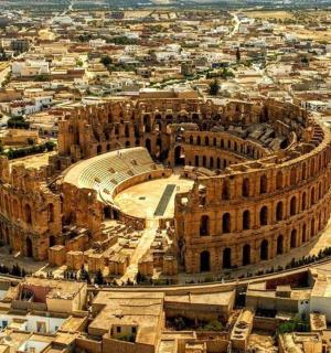 an aerial view of the colosseum and a city