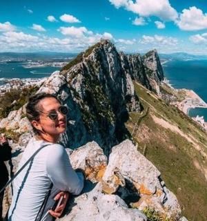 a woman standing on top of a mountain