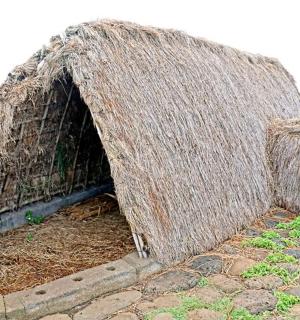 a small building made out of hay