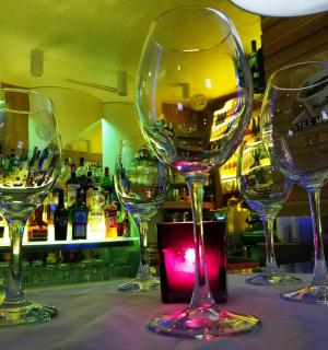 four wine glasses sitting on a table in a bar