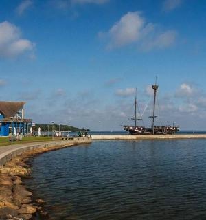 a body of water with a blue building and a house