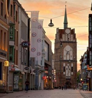 a city street with a clock tower in the distance