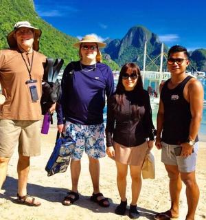 a group of people standing on a beach