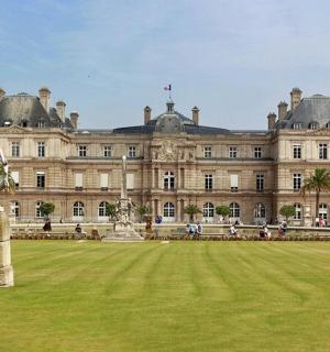 a large building with a statue in the middle of a field