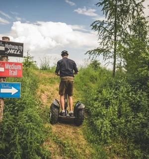 a man riding a four wheeler on a dirt road