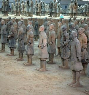 a group of statues of people standing in a row