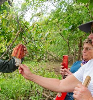 a woman is holding up a piece of meat