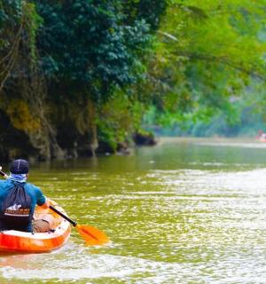a man is in a kayak on a river
