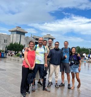a group of people standing in front of a fountain