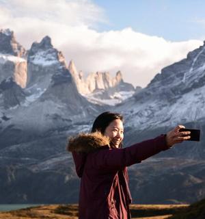 a man taking a picture of a mountain