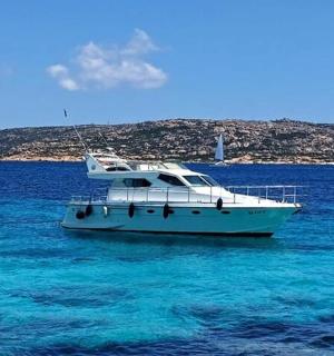 一艘白色的小船漂浮在蓝色的海水中