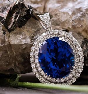 a blue sapphire and diamond ring on a rock