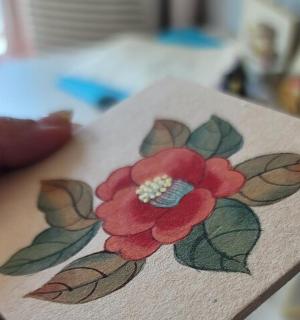 a drawing of a red flower on a piece of paper