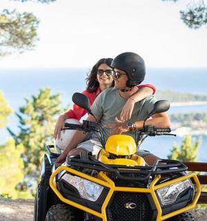 a man and woman riding on a four wheeler