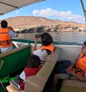 a group of people sitting in a boat on the water