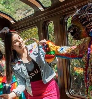 two girls riding on a train with a costume