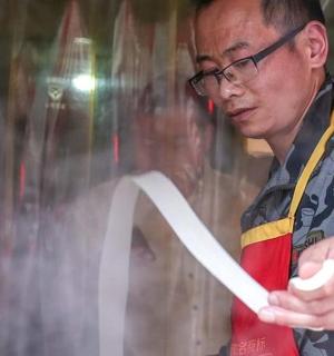 a man is holding a piece of paper