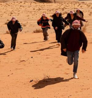 a group of people walking in the desert