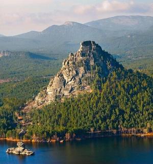 a large mountain in the middle of a lake