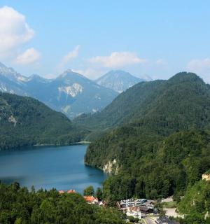 a view of a lake with a castle and mountains
