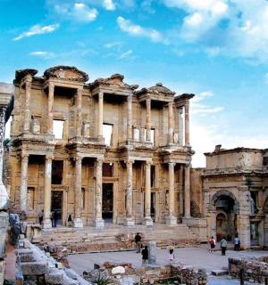 an ancient building with a statue in front of it