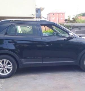 a black car parked in a parking lot