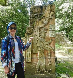 a woman standing in front of a statue