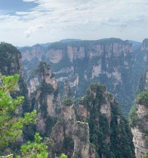 a view of a mountain range with trees and rocks