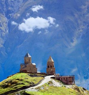 a castle on top of a hill with a mountain