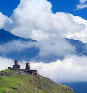 a castle on top of a hill in the clouds