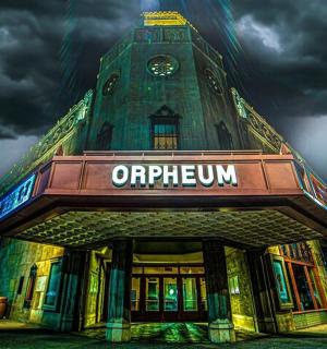 a building with a clock tower with a sign on it