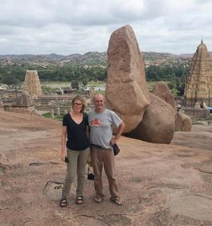 a man and woman standing in front of some rocks