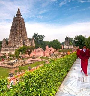 two men walking down a path in front of a temple