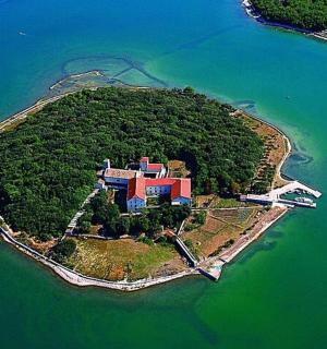 an island in the water with a building on it