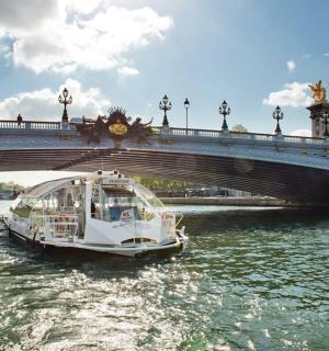 a boat in the water under a bridge
