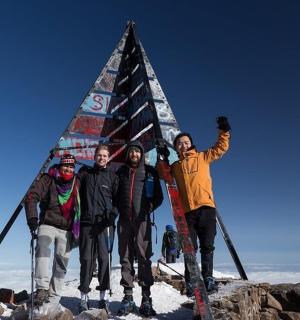 a group of people standing on top of a pyramid