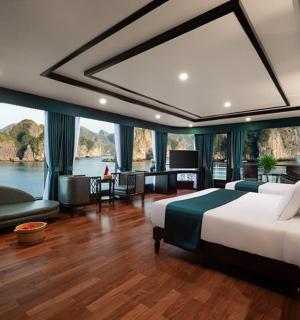 a bedroom with a large bed with a view of the water