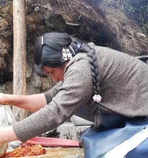 a woman is eating food on the ground