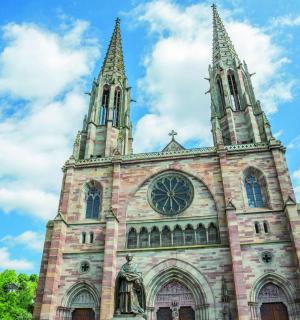 a church with two towers and a clock on it