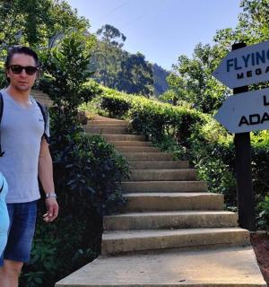a man and a woman standing next to a sign