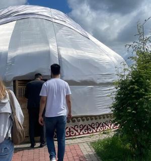 a group of people walking into a large white dome