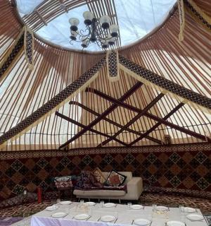 a room with a table in a yurt