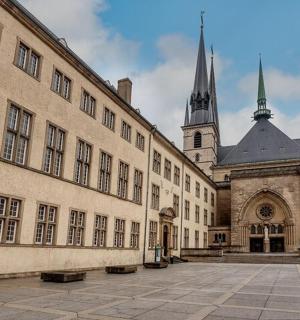 a large building with a church in the background