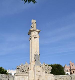 a monument with statues on top of a building