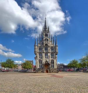 a large building with a tower on a street