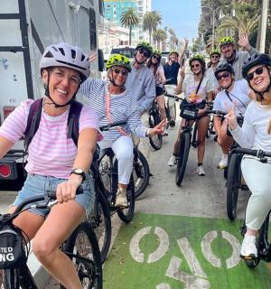 a group of people riding bikes on a street